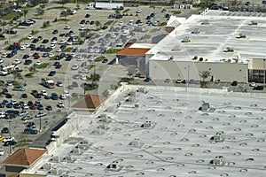 View from above of american grocery store with many parked cars on parking lot with lines and markings for parking