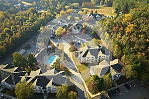 View from above of apartment residential condos between yellow fall trees in suburban area in South Carolina. American