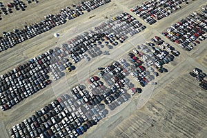 View from above of big parking lot with parked used cars after accident ready for sale. Auction reseller company selling