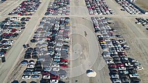 View from above of big parking lot with parked used cars after accident ready for sale. Auction reseller company selling