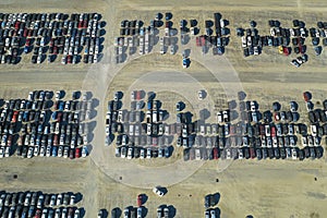 View from above of big parking lot with parked used cars after accident ready for sale. Auction reseller company selling