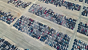 View from above of big parking lot with parked used cars after accident ready for sale. Auction reseller company selling