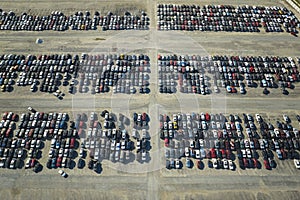 View from above of big parking lot with parked used cars after accident ready for sale. Auction reseller company selling