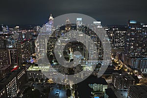 View from above of brightly illuminated high skyscraper buildings in downtown district of Atlanta city in Georgia, USA