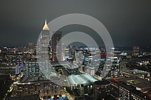 View from above of brightly illuminated high skyscraper buildings in downtown district of Atlanta city in Georgia, USA