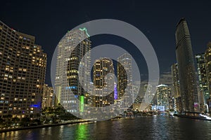 View from above of brightly illuminated high skyscraper buildings in downtown district of Miami Brickell in Florida, USA