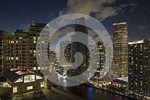 View from above of brightly illuminated high skyscraper buildings in downtown district of Miami Brickell in Florida, USA