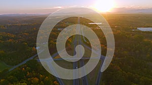 View from above of busy american highway with fast moving traffic between evening autumn woods in South Carolina