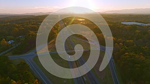 View from above of busy american highway with fast moving traffic between evening autumn woods in South Carolina