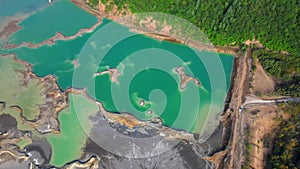 View from above. The camera flies over a chemical lake with turquoise water. Tailings dump of the Khrustalnenskiy mining