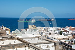 Town with part of the Santa Ana Cathedral, sea and freighter in Las Palmas on Gran Canaria, Spain