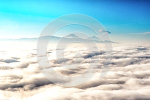 above the clouds with in the distance the popocatepetl volcano, Mexico photo