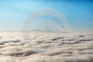 above the clouds with in the distance the popocatepetl volcano, Mexico photo