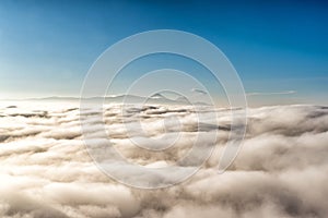 Above the clouds with in the distance the popocatepetl volcano, Mexico photo