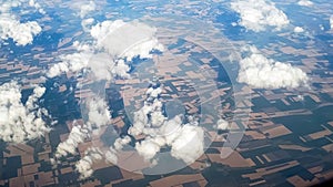 View above the clouds on ground divided by fields