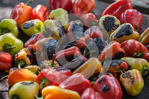 View from above of colorful red, green and yellow stuffed veggy savory bell peppers grilling on a BBQ