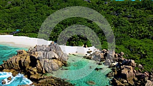 view from above at Couple on Anse Cocos beach or Petite Anse Beach Seychelles La Digue Island
