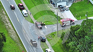 View from above of crash site with emergency services personnel and vehicles responding to accident on american street