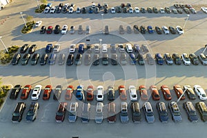 View from above of dealers outdoor parking lot with many brand new cars in stock for sale. Concept of development of
