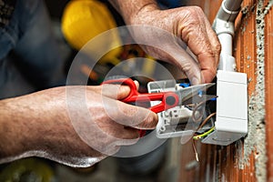 Electrician at work on a residential electrical system. Electricity