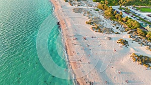 View from above of evening Blind Pass beach with white sands and relaxing tourists on Manasota Key, USA. People enjoying