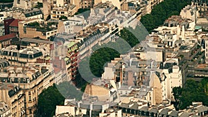 View from above of a green steet with residential buildings and classic roofs in Paris, France