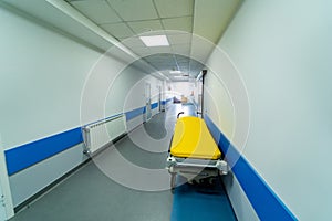 View from above on gurney or emergency bed in empty corridor of a new clinic or hospital. Closeup.