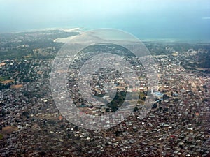 View from above of a huge city with many private houses below. View from the plane