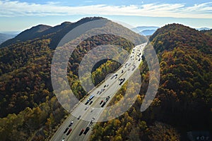 View from above of I-40 freeway in North Carolina heading to Asheville through Appalachian mountains in golden fall
