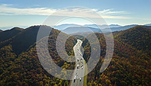 View from above of I-40 freeway route in North Carolina leading to Asheville thru Appalachian mountains with yellow fall