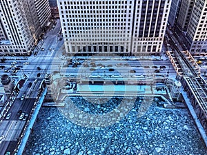 View from above of ice chunks on a blue colored Chicago River.