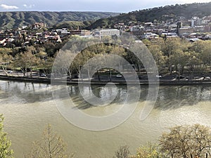 View from above of the Kura River and automobile road with car traffic in Tbilisi, Georgia