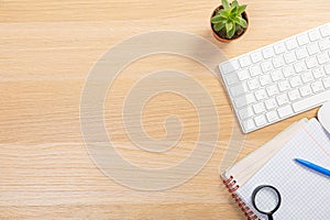 View from above.Laptop,pen,tablet,smart phone and cup of coffee on white office desk with copy space