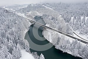 View from above on motorway bridge over the dark blue river Lech