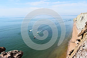 View from above of the movement of three boats near the rocky and sandy shore. Qeshm Island, Iran