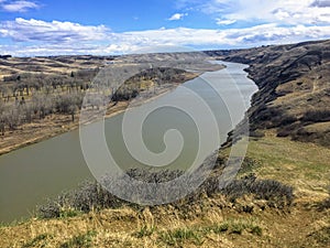 A view above of the Old Man River cutting through the valley and plains of Lethbridge, Alberta, Canada