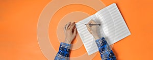 view from above, person taking down the notes in notebook, empty blank paper mockup with copy space