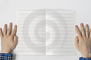 view from above, person taking down the notes in notebook, empty blank paper mockup with copy space