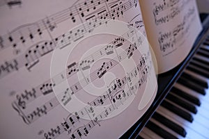 View from above of piano keys and sheet music