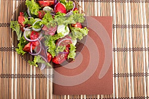 View from above on a plate with fresh salad of raw tomatoes