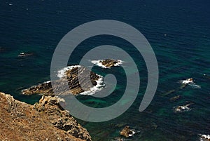 A view from above on the rocks of Arrifana bay with ransparent turquose water photo