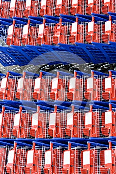 View from above of rows of blue and red shopping carts