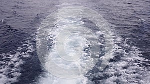 View from above of sea waves produced by a ships engine