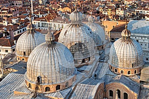 View from above at sunset with the domes of Saint Marks Basilica (Basilica di San Marco) in Venice. Architectural detail
