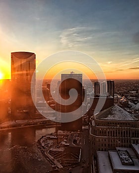 View from above of sunset over frozen Chicago River and horizon over Chicagoland.