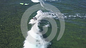 A view from above of the surfers in the ocean