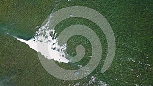 A view from above of the surfers in the ocean