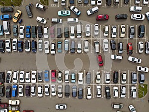 A view from above to the lines of parked cars. Heavy traffic in the parking lot. Searching for spaces in the busy car park.