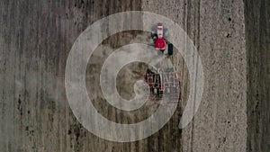 View from above, tractor working in a field. The tractor plows the field. Agricultural work. Agricultural works for