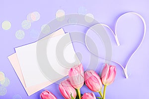 View from above tulips and heart with copy space on violet background. Mockup for womens day, 8 March Valentine's day